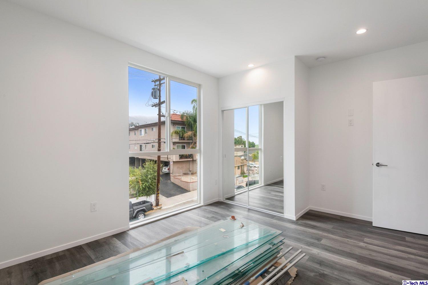 7064 Greeley Street, Unit 202 Tujunga, CA 91042 - Photo 31 of 45 wooden floor in an empty room with a window