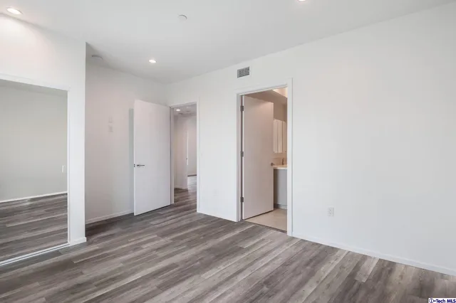 a view of a room with wooden floor and a window