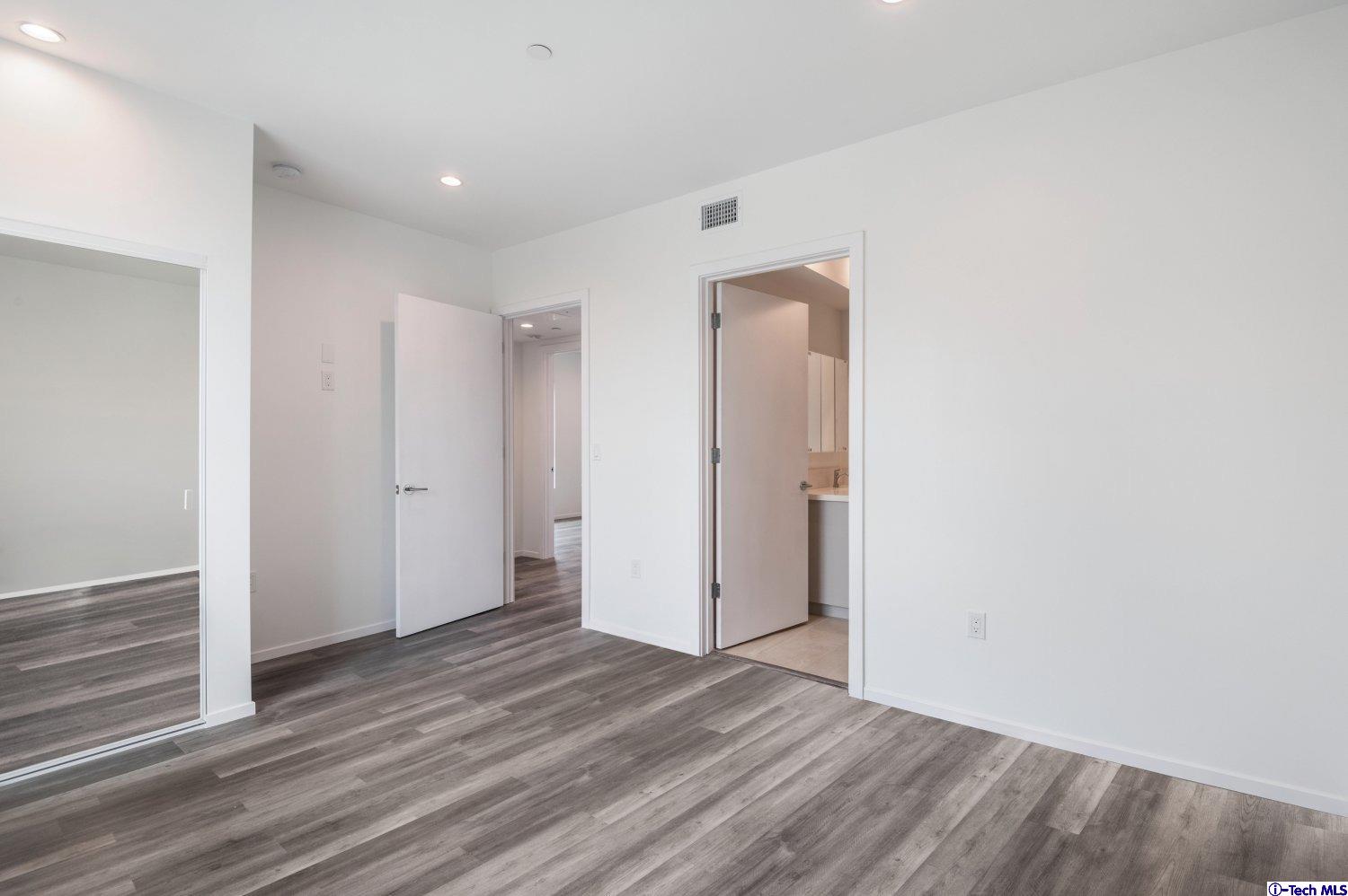 7064 Greeley Street, Unit 202 Tujunga, CA 91042 - Photo 32 of 45 a view of a room with wooden floor