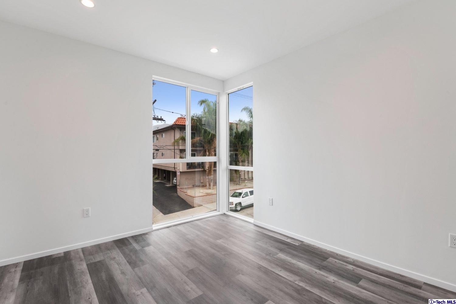 7064 Greeley Street, Unit 202 Tujunga, CA 91042 - Photo 35 of 45 a view of a room with wooden floor and a window