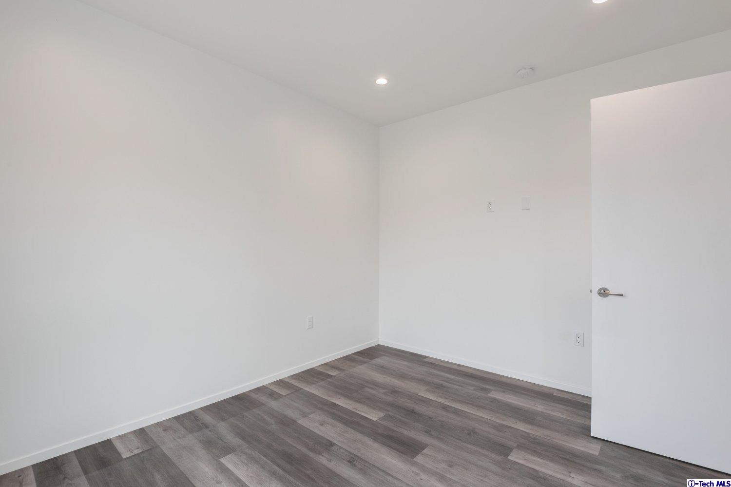 7064 Greeley Street, Unit 202 Tujunga, CA 91042 - Photo 39 of 45 a view of empty room with wooden floor