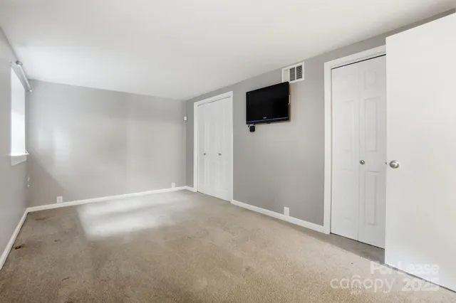 a view of a livingroom with an empty space and a window