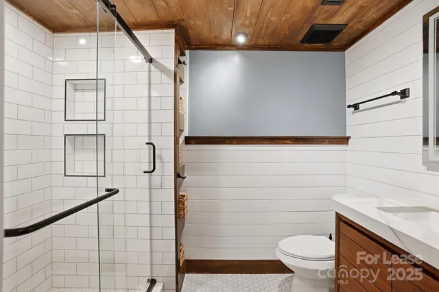a bathroom with a sink a toilet and vanity