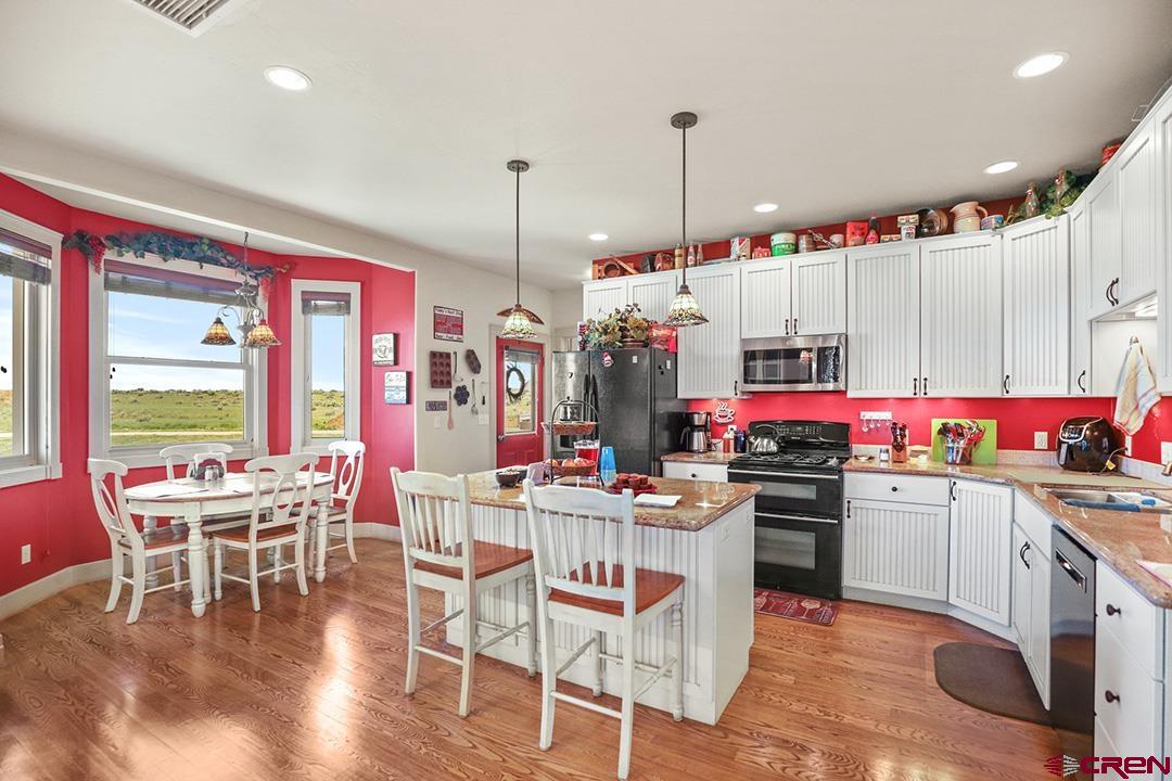 22259 Rd U Cortez, CO 81321 - Photo 13 of 35 a kitchen that has a lot of cabinets and stainless steel appliances