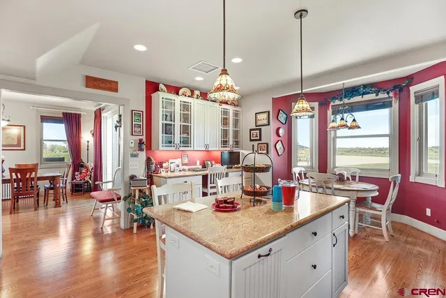 a kitchen that has a lot of countertop furniture and a chandelier