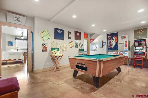 a living room with kitchen island furniture and a flat screen tv