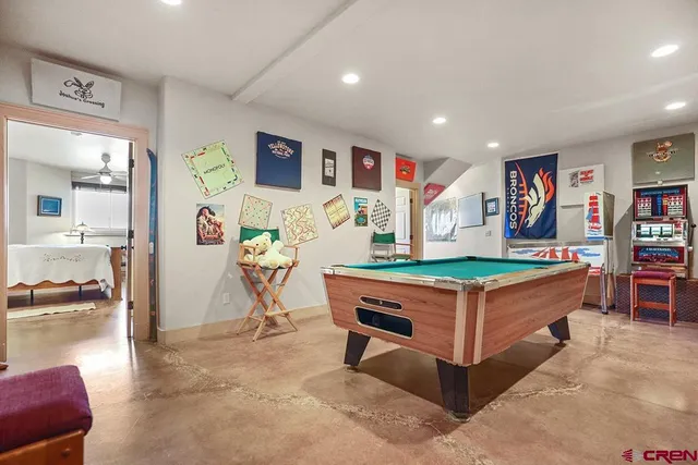 a living room with kitchen island furniture and a flat screen tv
