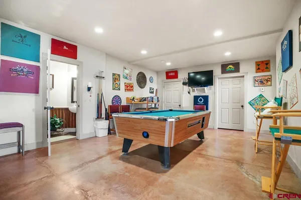 a kitchen with stainless steel appliances kitchen island granite countertop a refrigerator and a sink