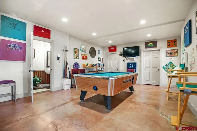 a kitchen with stainless steel appliances kitchen island granite countertop a refrigerator and a sink