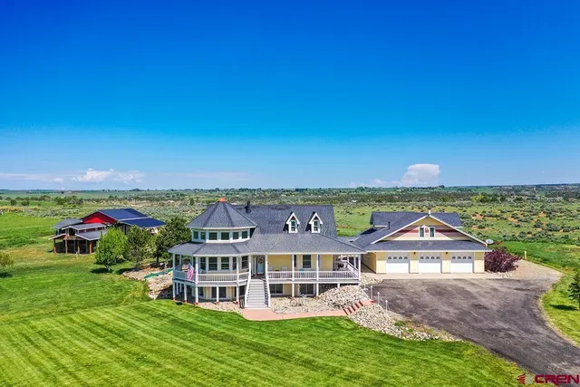 an aerial view of a house with a big yard