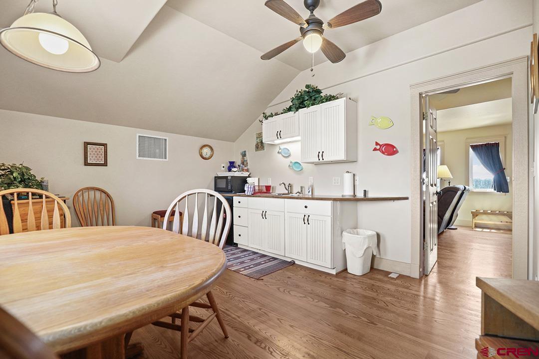 22259 Rd U Cortez, CO 81321 - Photo 27 of 35 a kitchen with a table chairs and white appliances
