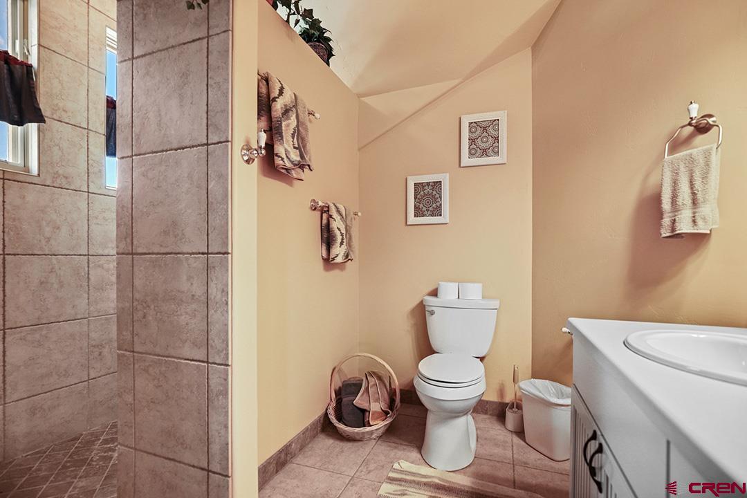 22259 Rd U Cortez, CO 81321 - Photo 28 of 35 a bathroom with a toilet and a shower