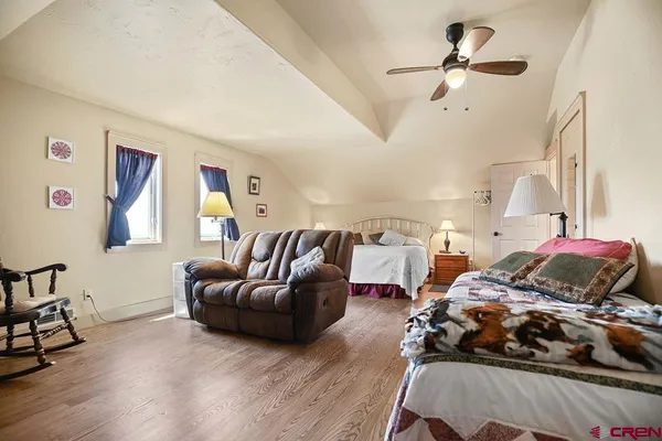 a bedroom with furniture and a large window
