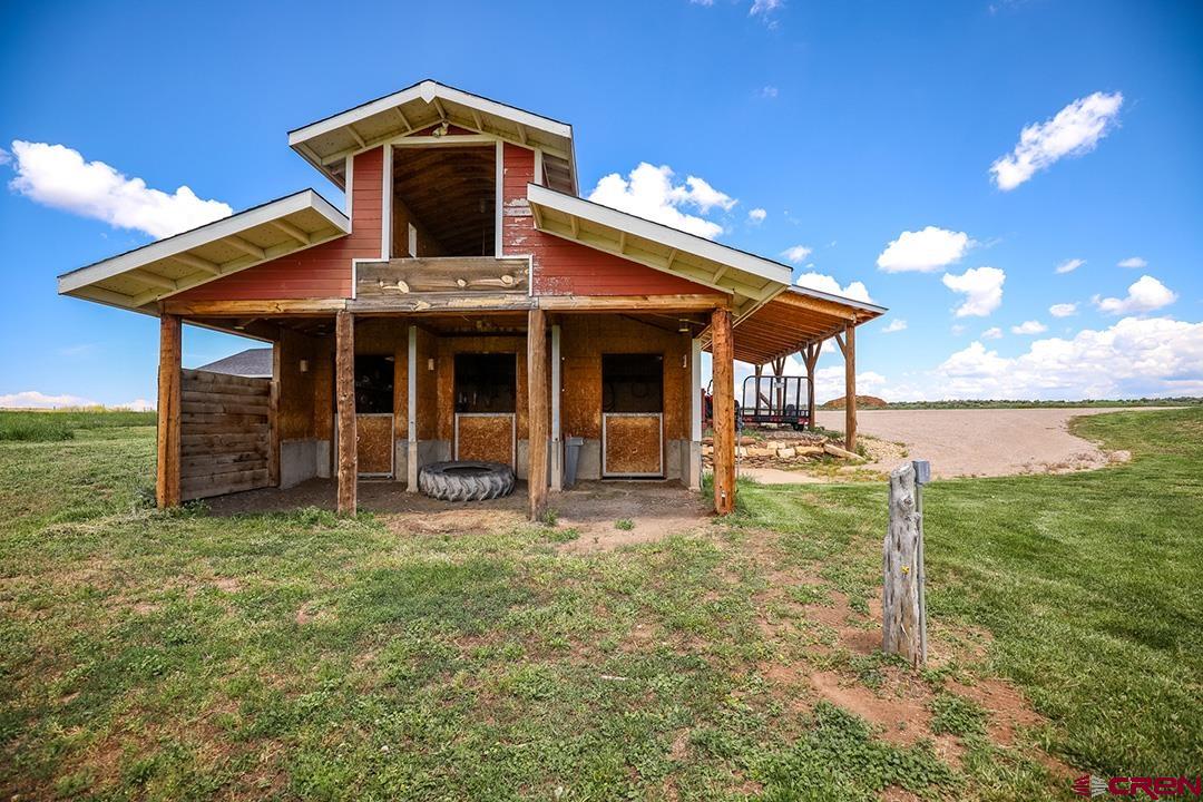 22259 Rd U Cortez, CO 81321 - Photo 33 of 35 a front view of a house with a yard