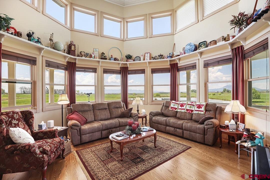 22259 Rd U Cortez, CO 81321 - Photo 10 of 35 a living room with furniture and a floor to ceiling windows
