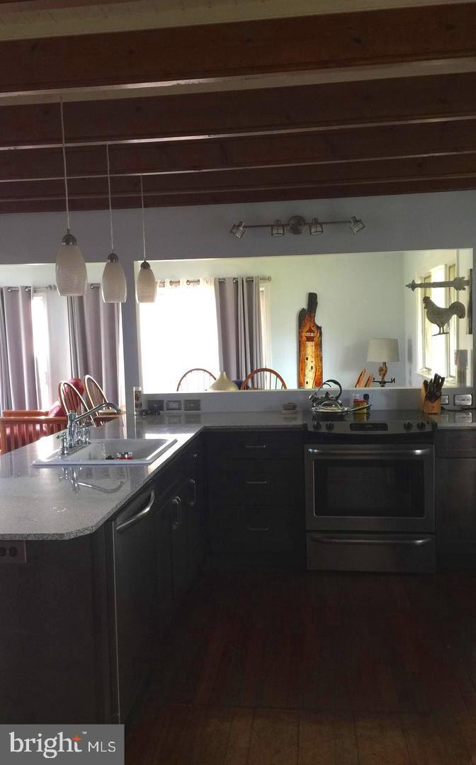 21552 Chicken Point Road Tilghman, MD 21671 - Photo 4 of 14 a kitchen with a sink and cabinets