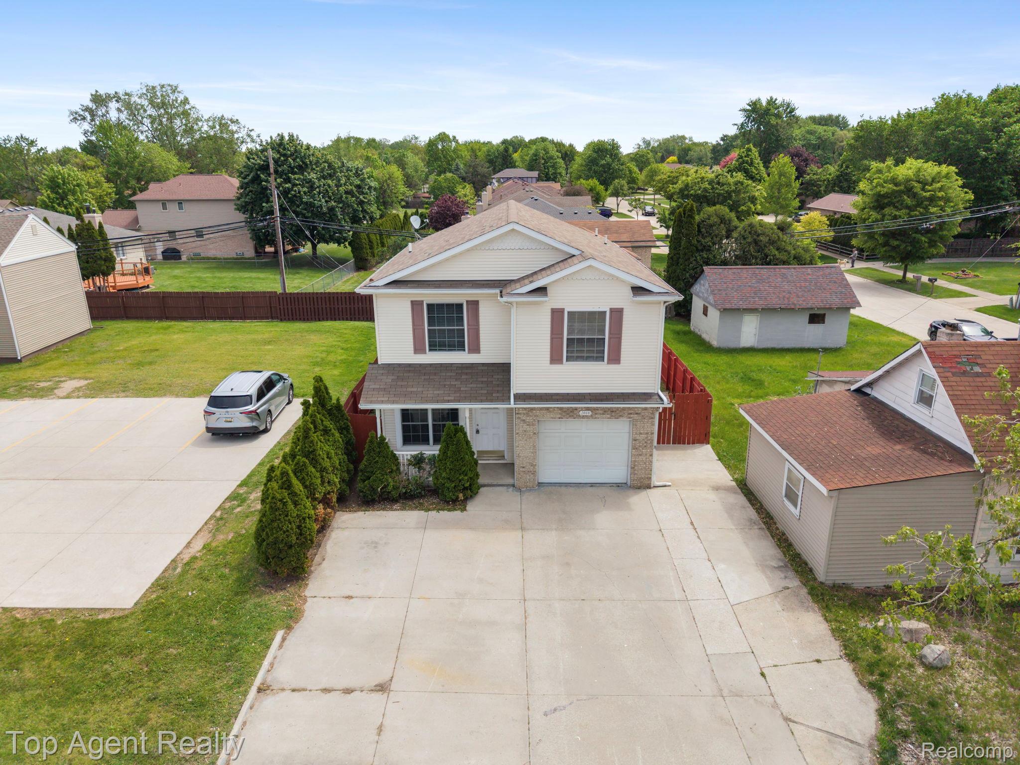 2018 John R Road Troy, MI 48083 - Photo 28 of 30 Traditional-style house featuring driveway and a garage