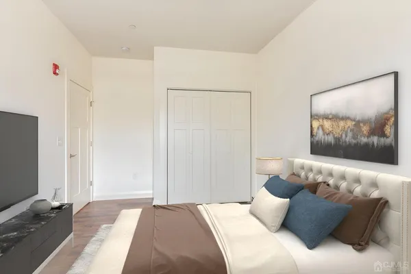 a bedroom with a bed and a painting on the wall