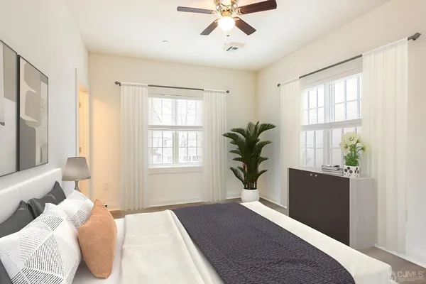 a bedroom with a large bed and a window
