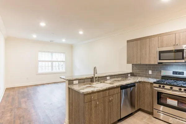 a kitchen with a sink stove and microwave