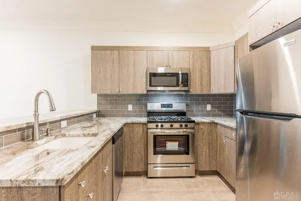 a kitchen with a sink a stove and refrigerator