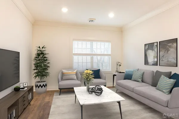 a living room with furniture plant and a window