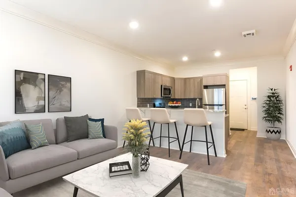 a living room with furniture and kitchen view