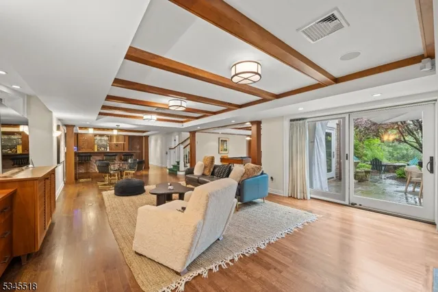 a view of a livingroom with furniture wooden floor and windows