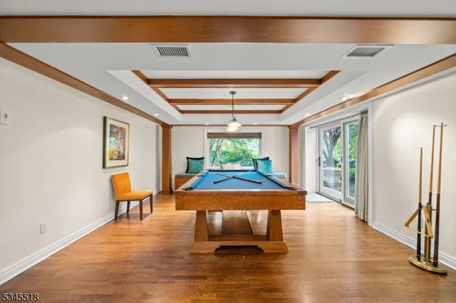 a dining room with furniture window and wooden floor