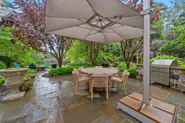a patio with a patio table and chairs