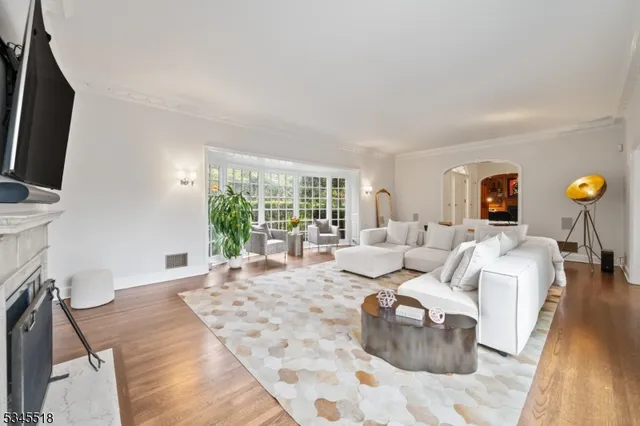a living room with furniture large window and flat screen tv