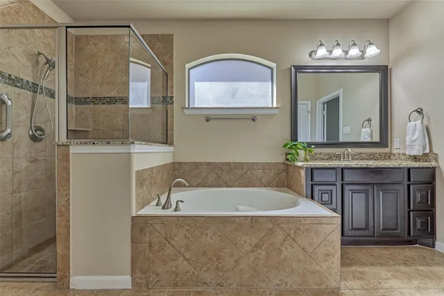 a bathroom with a tub and a mirror