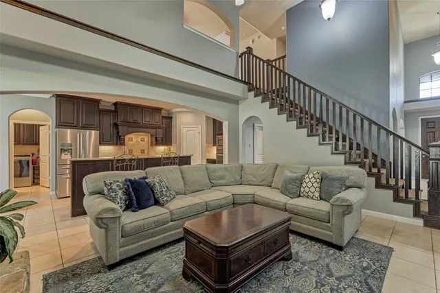 a living room with furniture and a potted plant