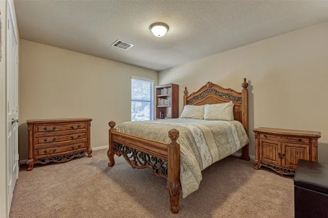 a bedroom with a bed and a dresser
