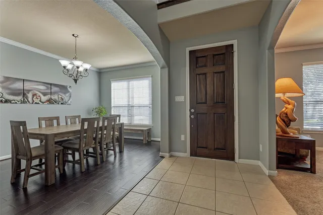 a view of a dining room with furniture and chandelier