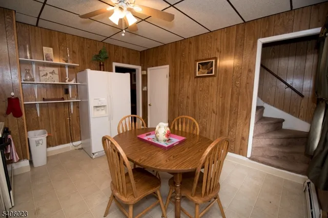 a dining room with furniture and a window