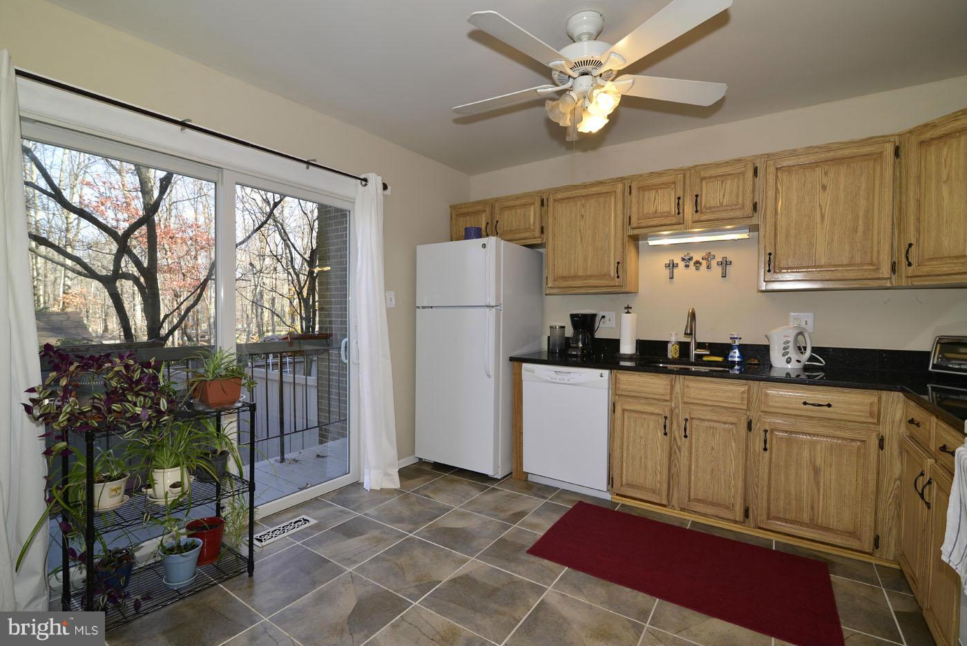 12019 Insha Court Reston, VA 20191 - Photo 5 of 27 a kitchen with stainless steel appliances granite countertop a refrigerator a sink a stove and white cabinets