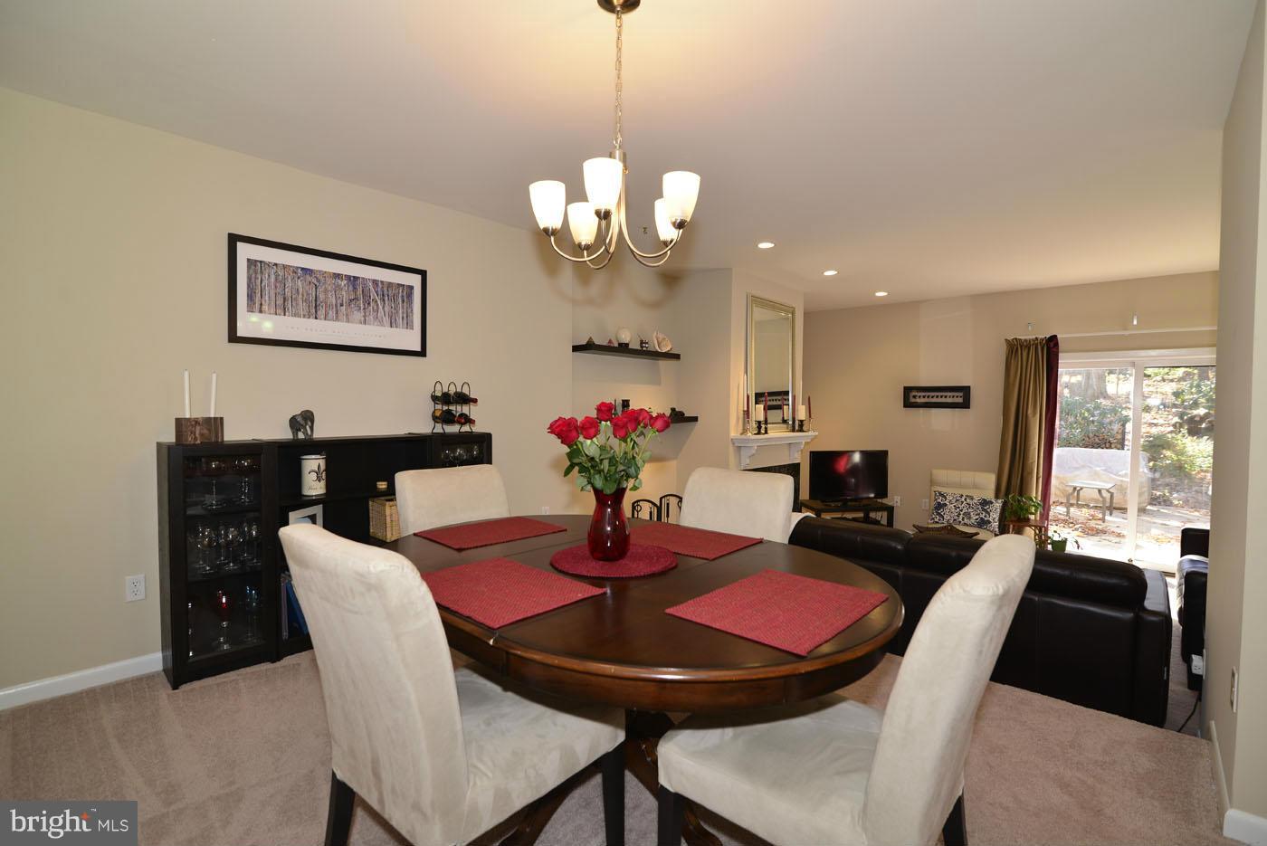 12019 Insha Court Reston, VA 20191 - Photo 8 of 27 a view of a dining room with furniture a chandelier and wooden floor