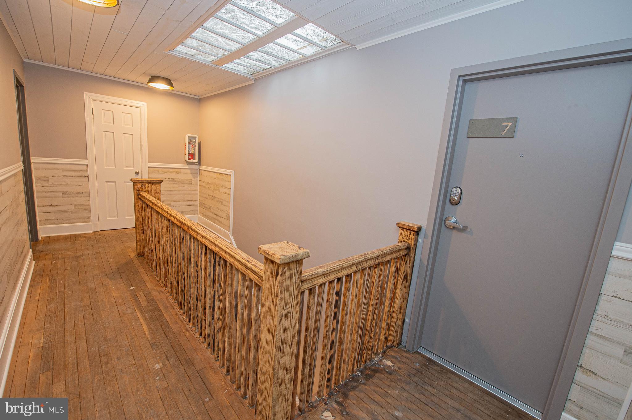 308 North Division Street, Unit 7 Salisbury, MD 21801 - Photo 12 of 56 a view of a hallway with wooden floor