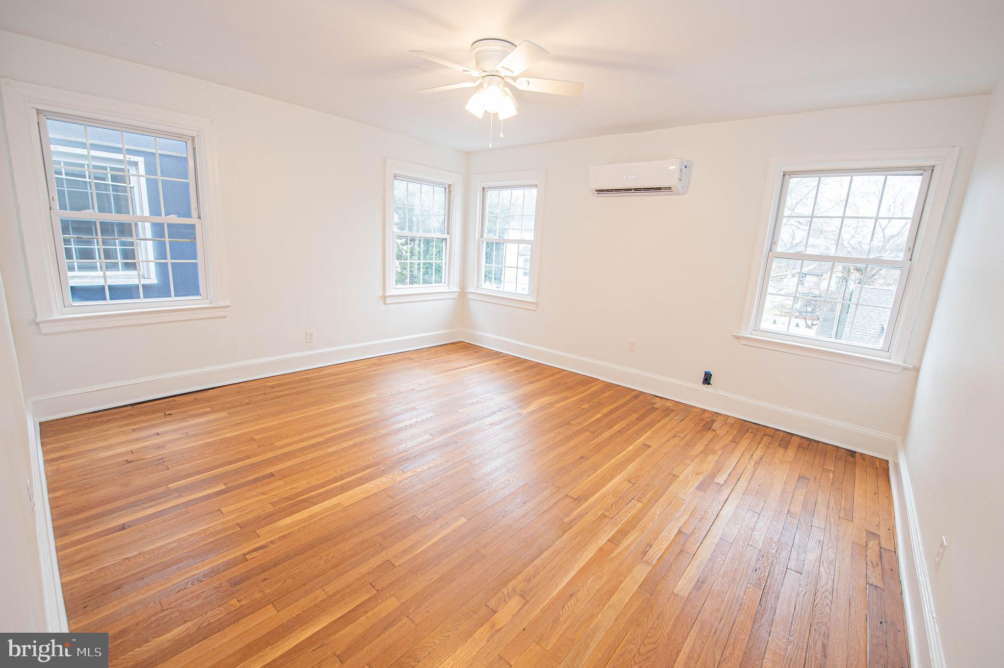 308 North Division Street, Unit 7 Salisbury, MD 21801 - Photo 19 of 56 wooden floor in an empty room with a window
