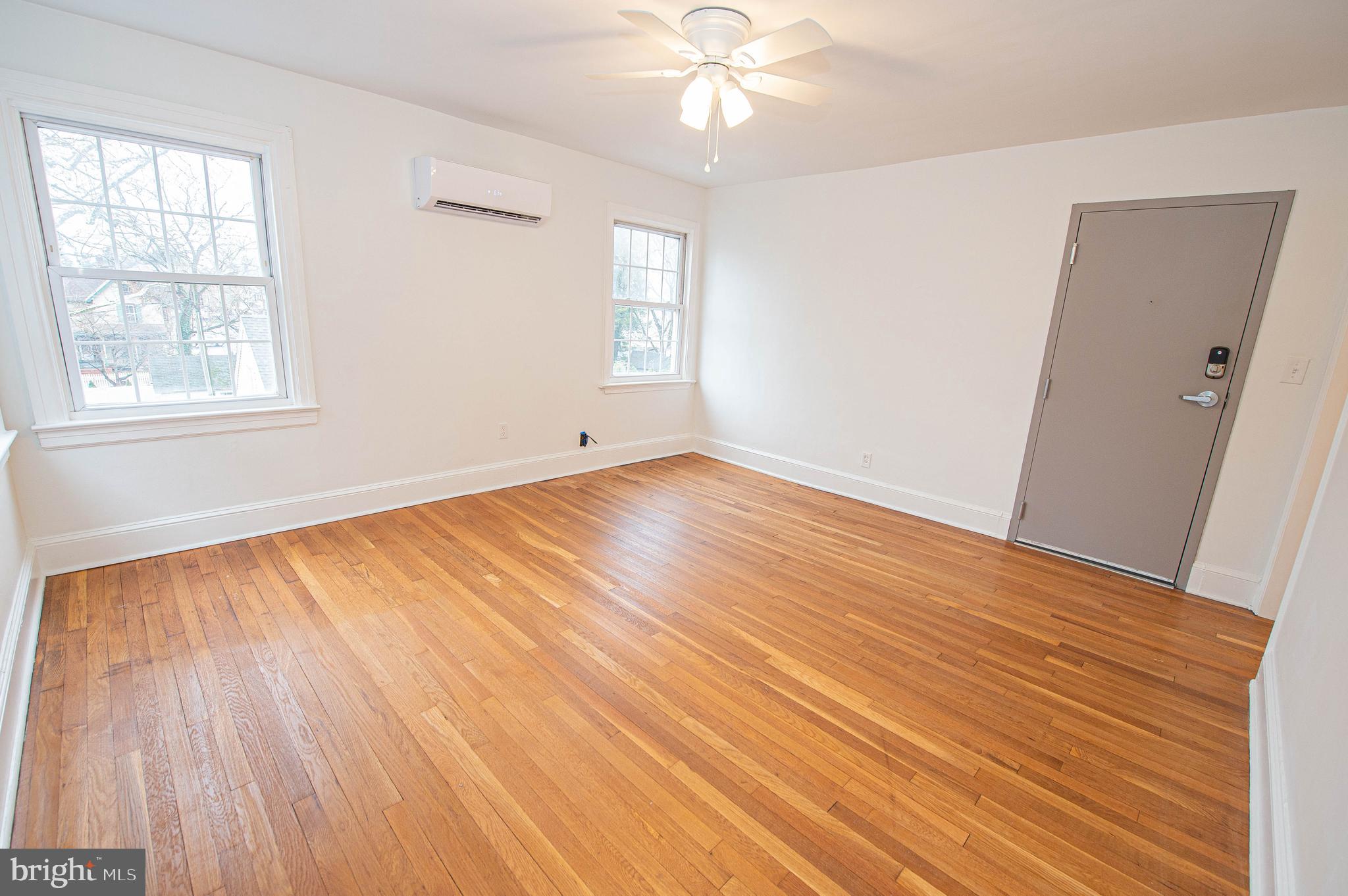 308 North Division Street, Unit 7 Salisbury, MD 21801 - Photo 20 of 56 wooden floor in an empty room with a window
