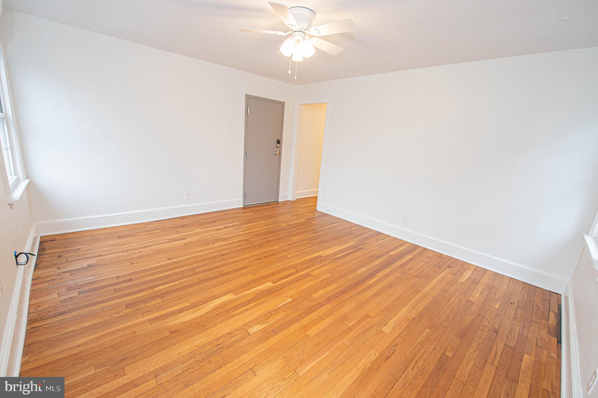 308 North Division Street, Unit 7 Salisbury, MD 21801 - Photo 21 of 56 a view of an empty room with wooden floor