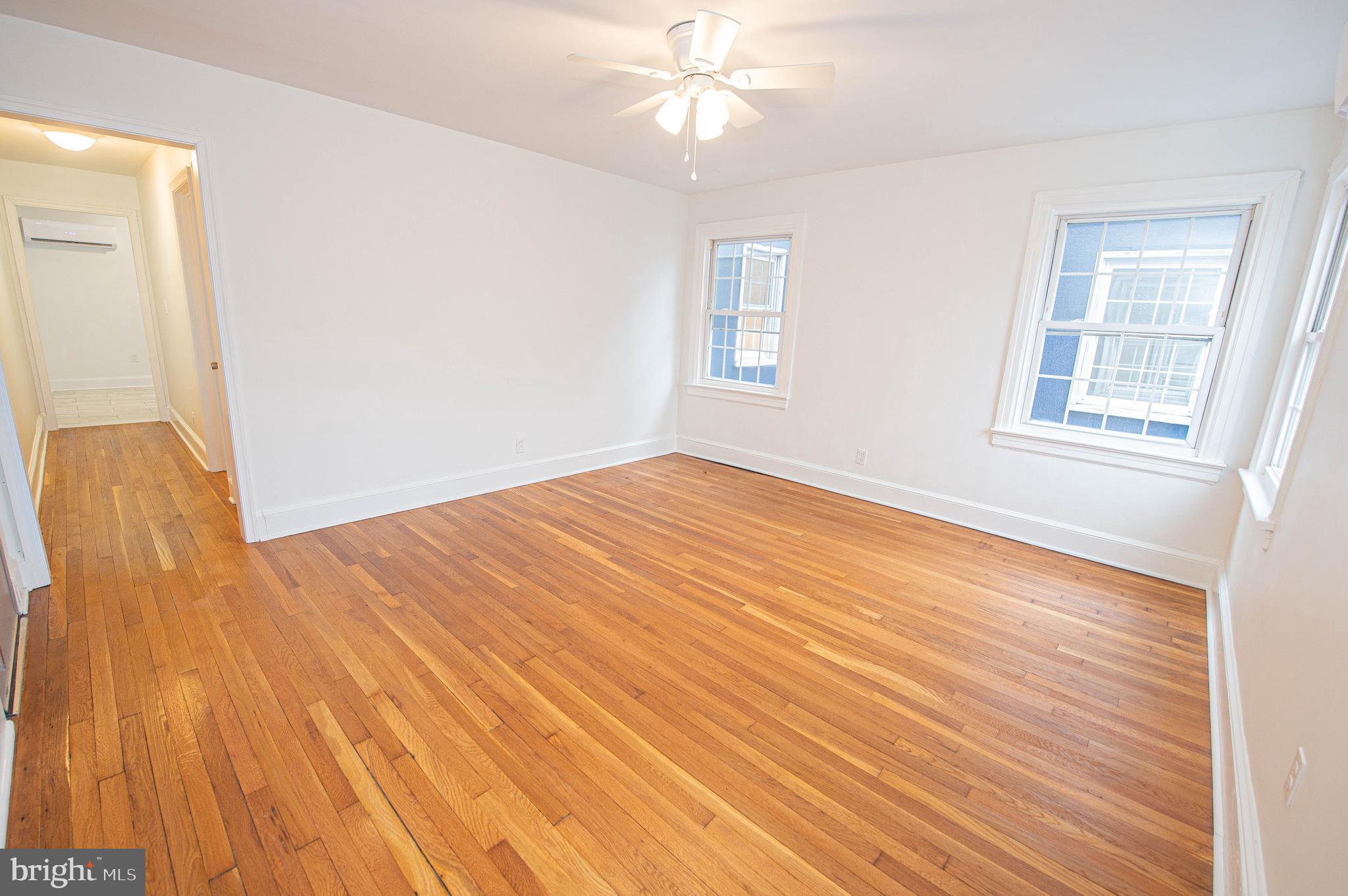 308 North Division Street, Unit 7 Salisbury, MD 21801 - Photo 22 of 56 an empty room with wooden floor fan and windows