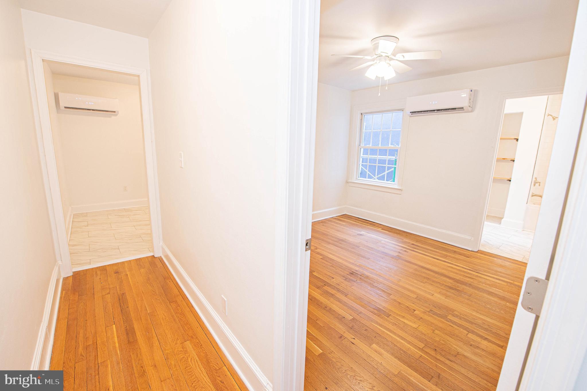 308 North Division Street, Unit 7 Salisbury, MD 21801 - Photo 26 of 56 a view of a room with wooden floor and a ceiling fan