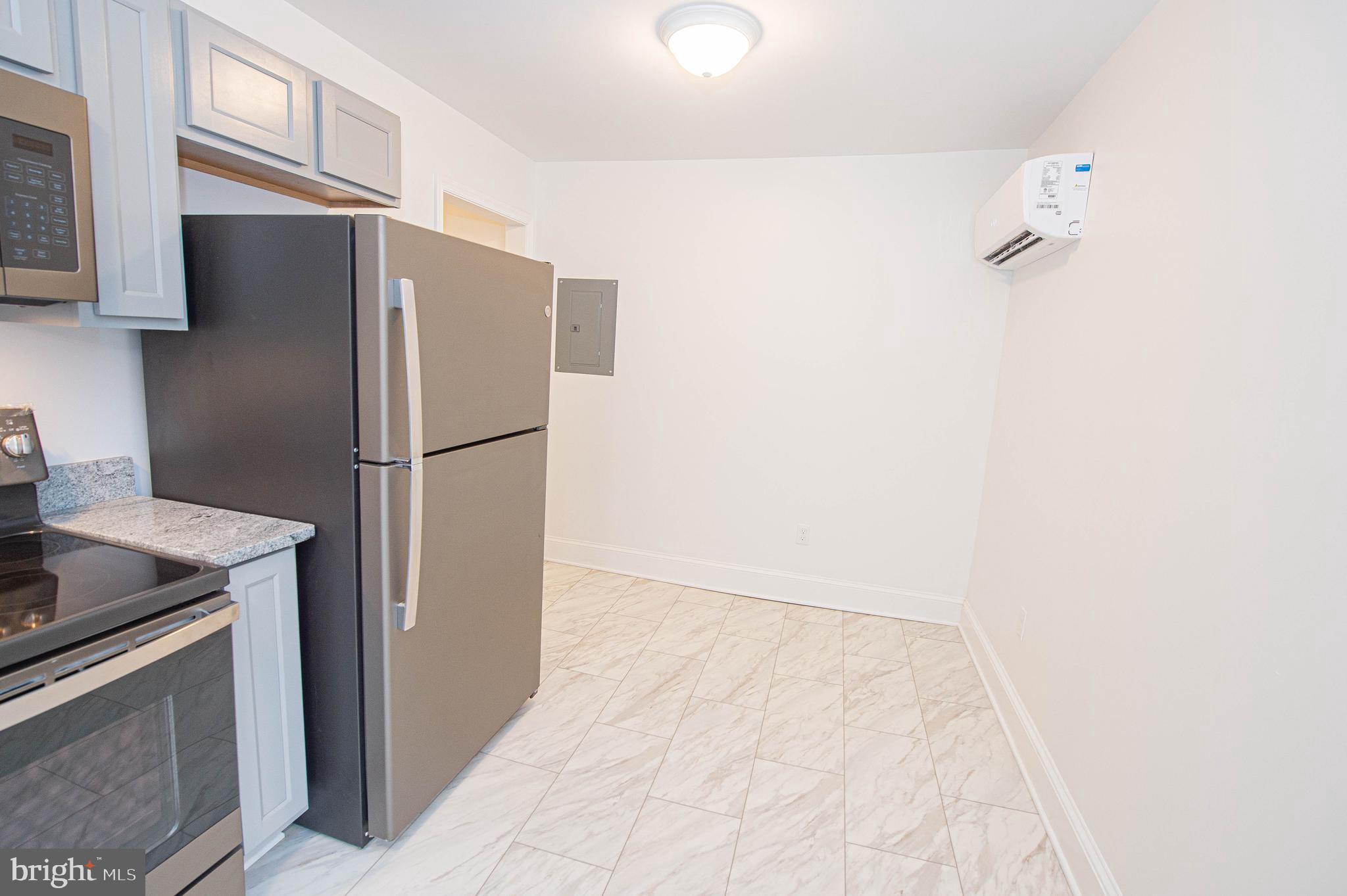 308 North Division Street, Unit 7 Salisbury, MD 21801 - Photo 39 of 56 a kitchen with a refrigerator and a stove