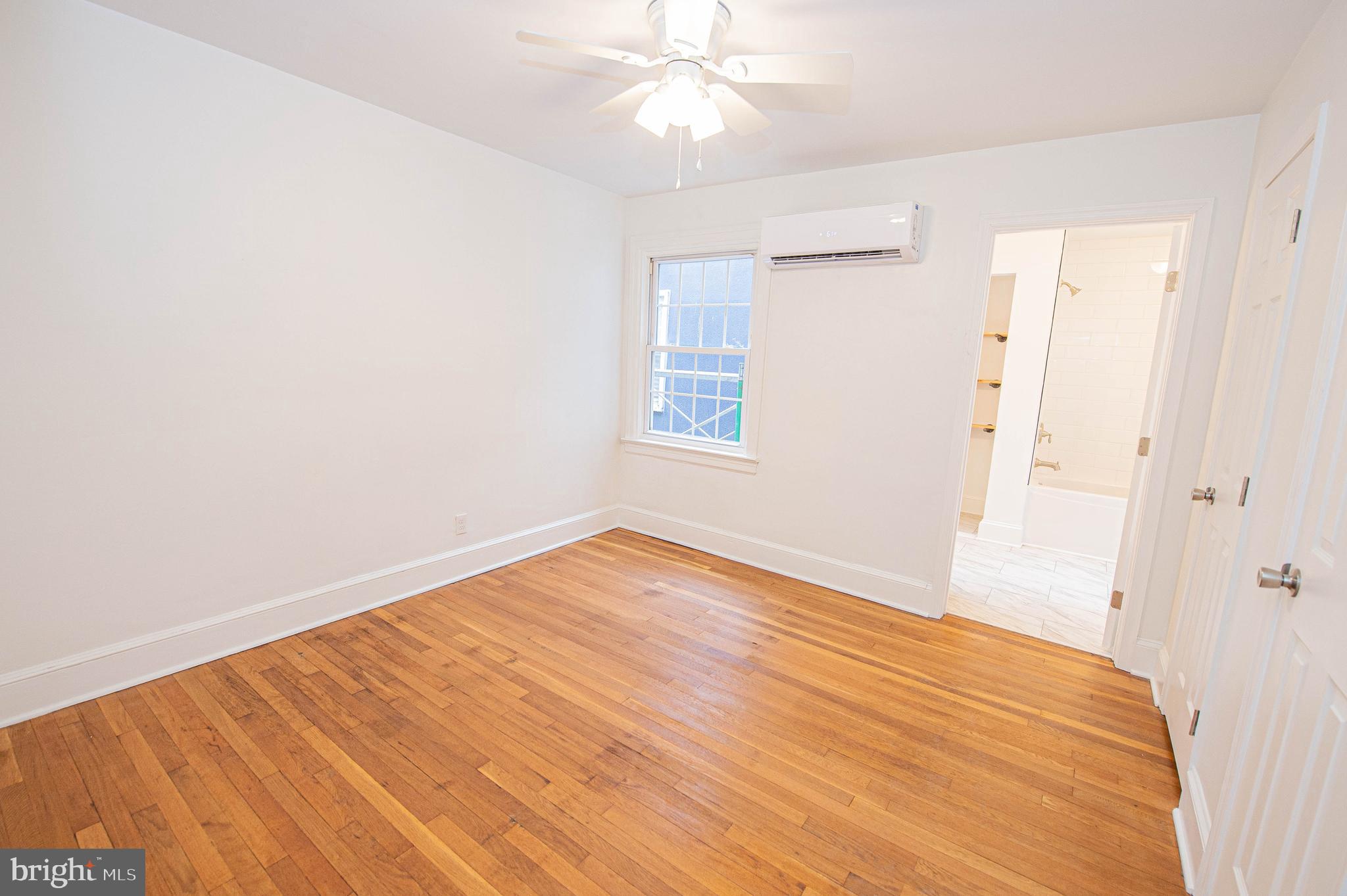 308 North Division Street, Unit 7 Salisbury, MD 21801 - Photo 41 of 56 wooden floor in an empty room with a window