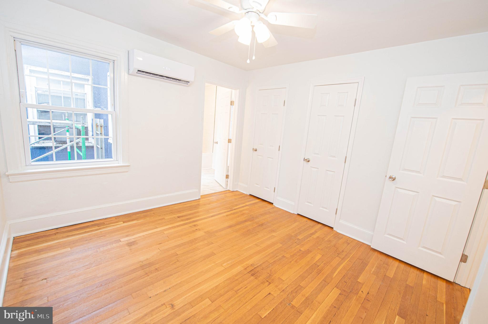 308 North Division Street, Unit 7 Salisbury, MD 21801 - Photo 42 of 56 a view of empty room with wooden floor and fan
