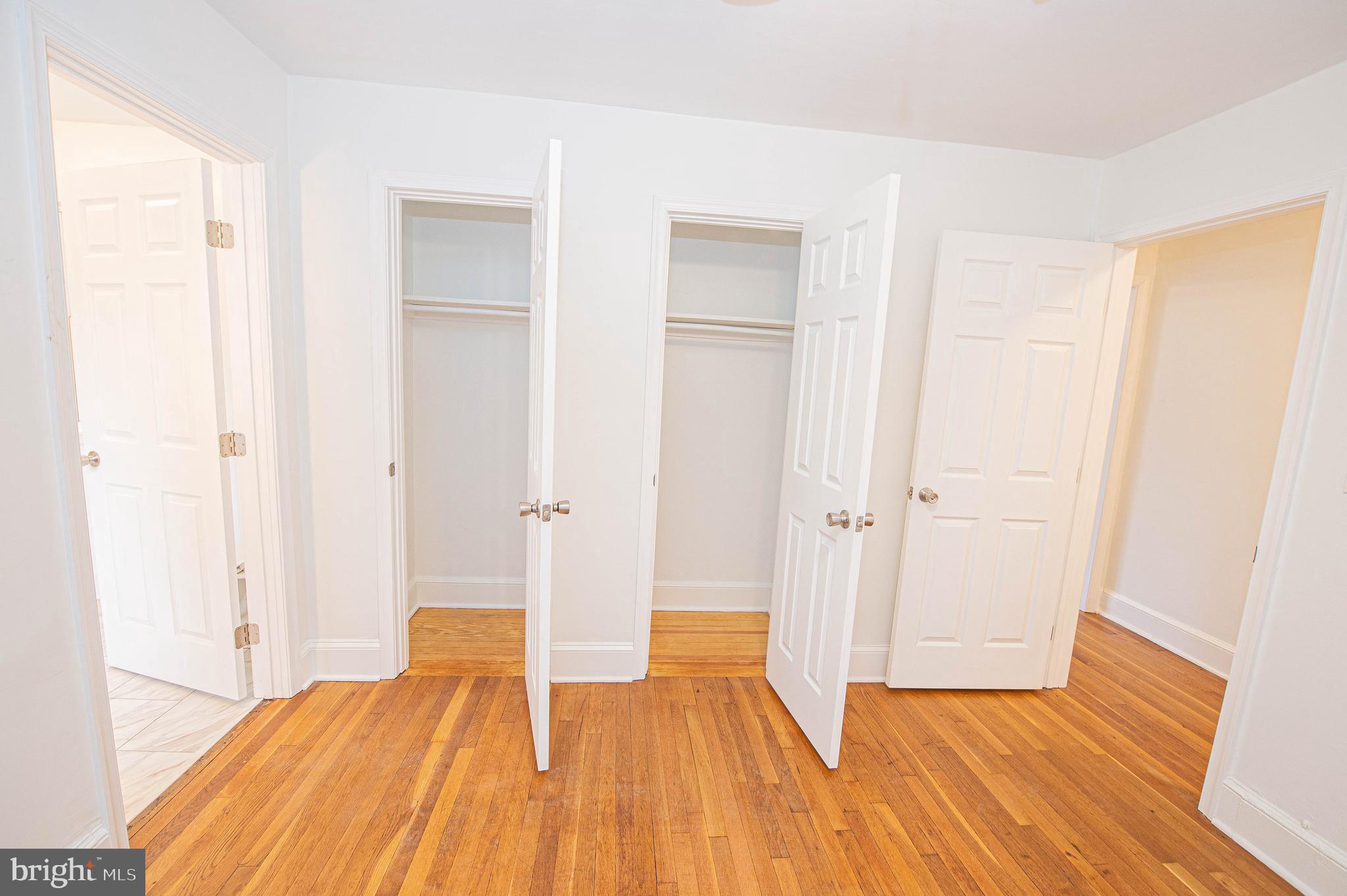 308 North Division Street, Unit 7 Salisbury, MD 21801 - Photo 44 of 56 a view of a bedroom with wooden floor and closet