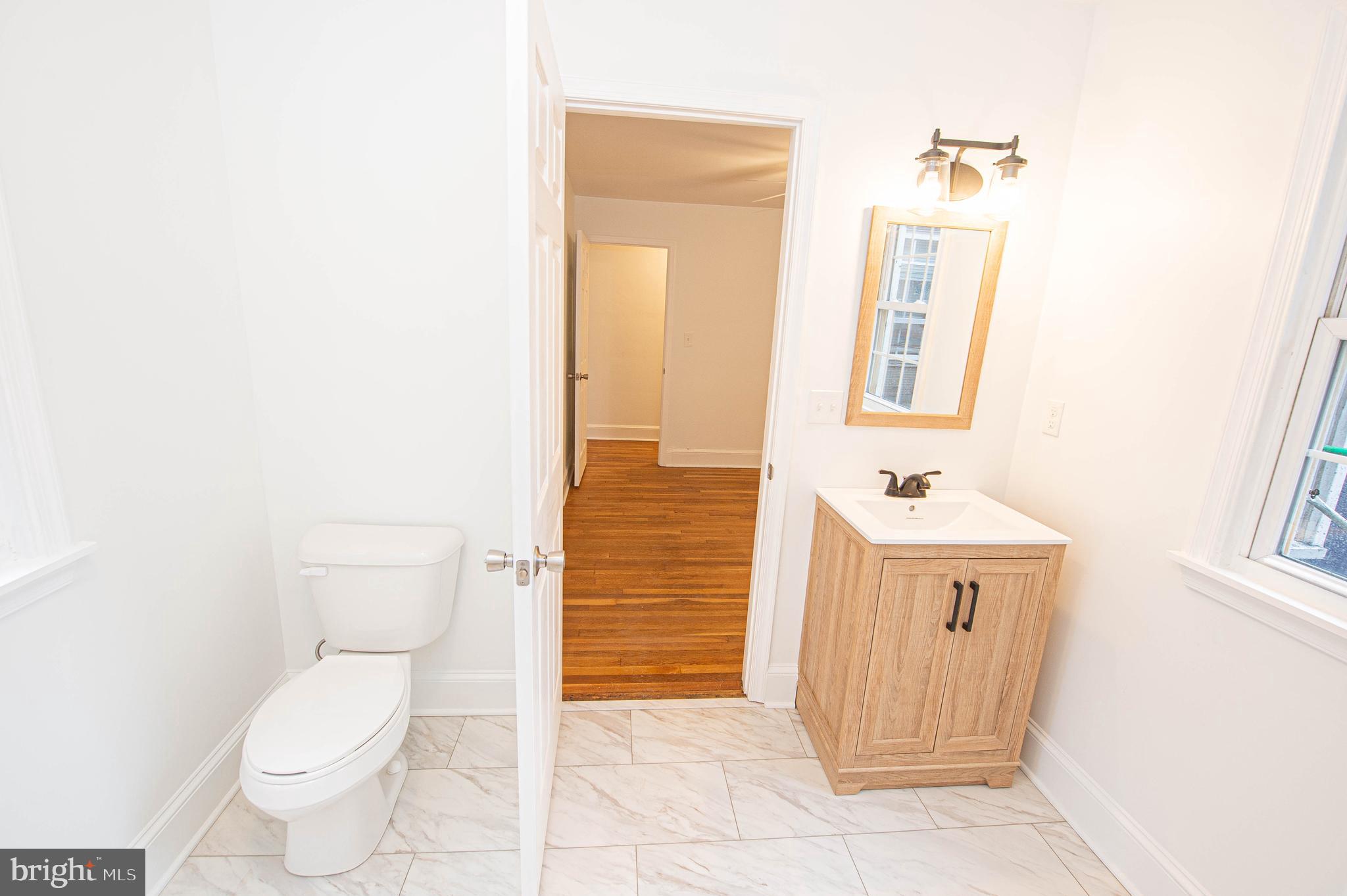 308 North Division Street, Unit 7 Salisbury, MD 21801 - Photo 48 of 56 a bathroom with a sink a toilet and shower