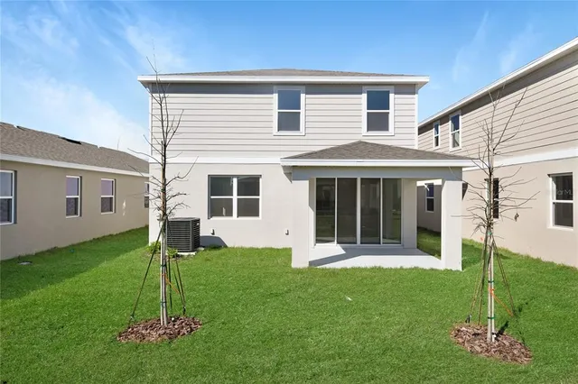 a front view of a house with a garden and yard
